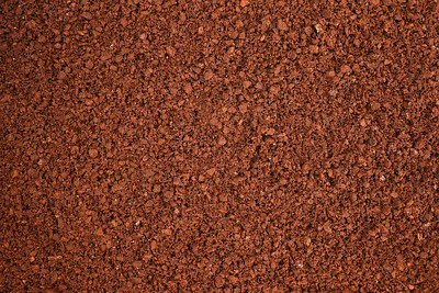 Close-up of textured brown soil surface.